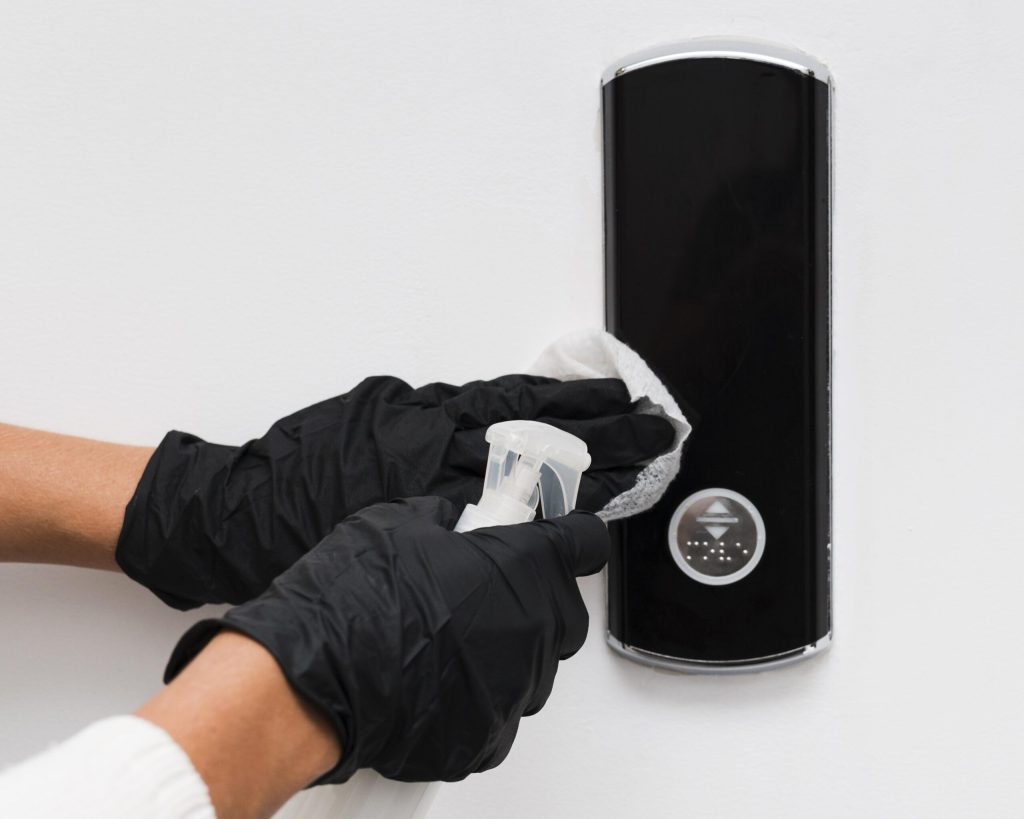 hands-with-gloves-disinfecting-door-bell (1)